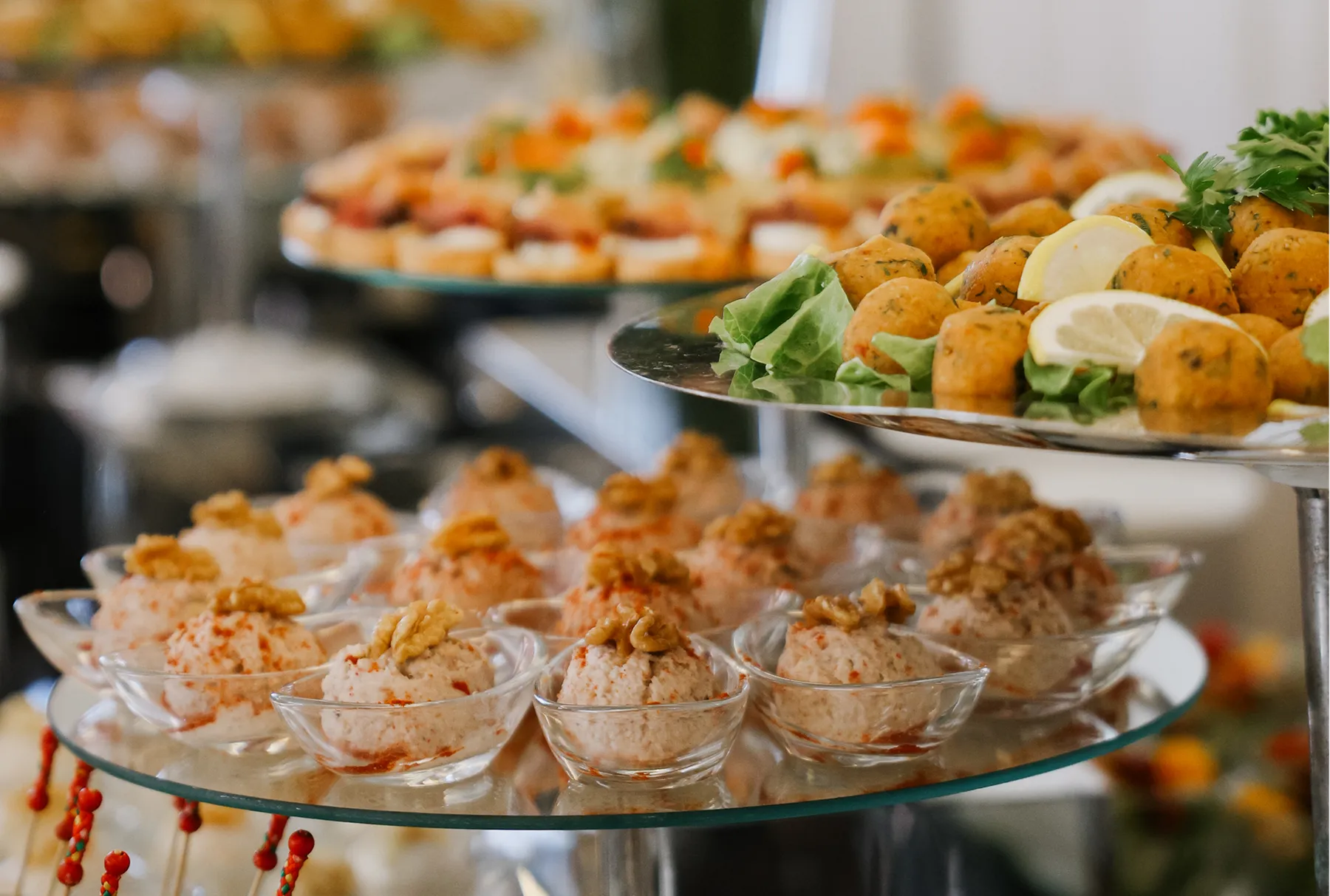 Canapés of white fish and caviar on tomato, served on individual porcelain spoons